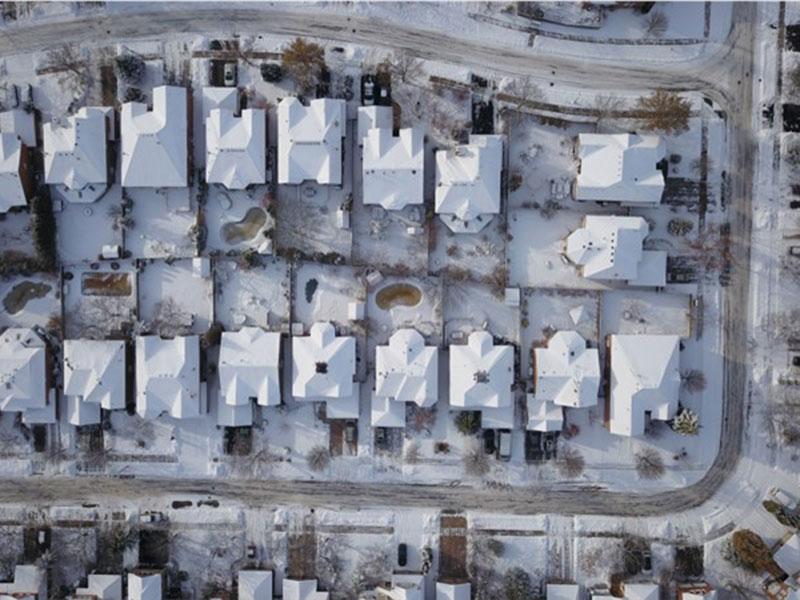 top aerial view of houses in a row in a cold region