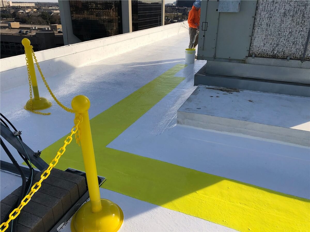 men applying sealant to commercial rooftop