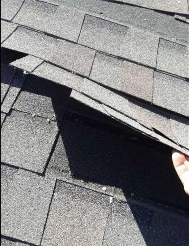 damaged shingles after a storm