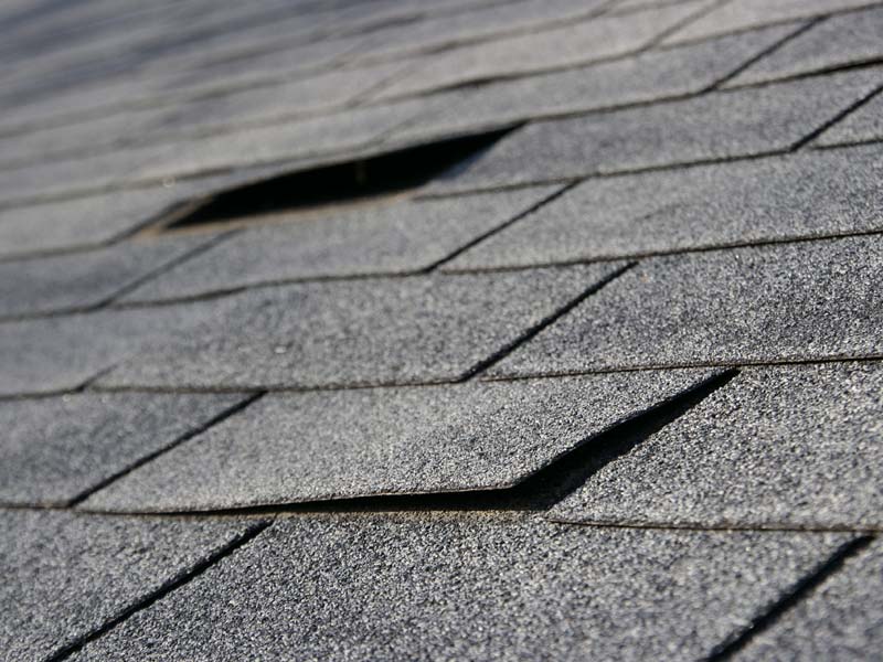closeup of damaged asphalt roof