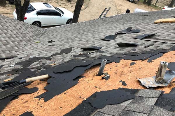 rooftop missing shingles after a storm
