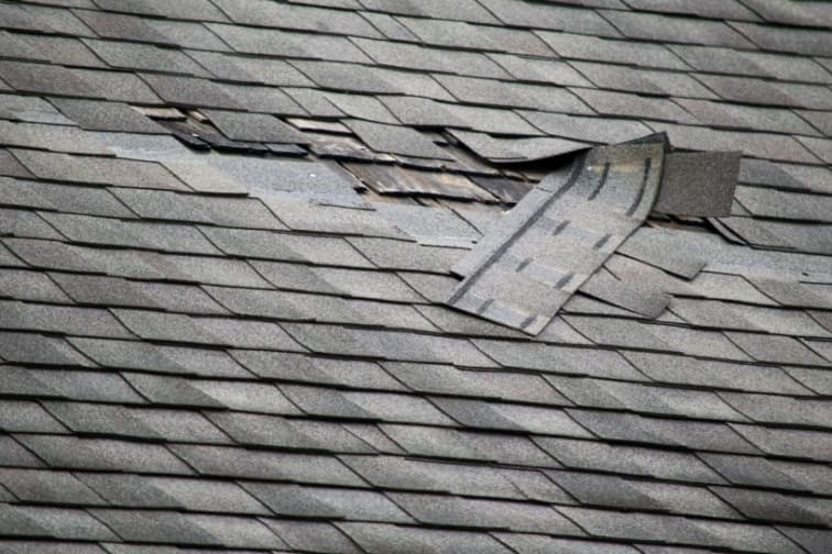 A close-up of damaged roof shingles